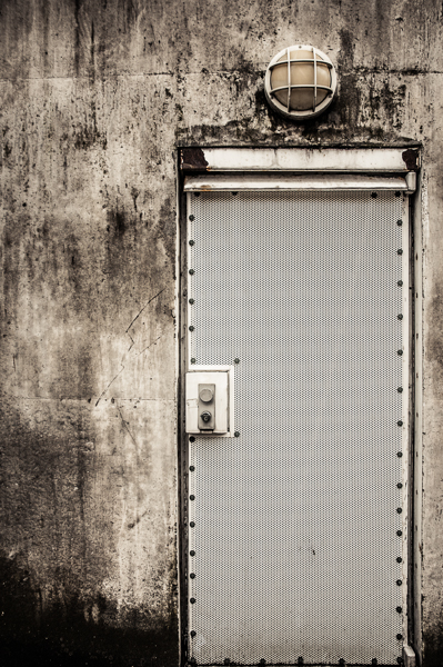 A heavily protected door in a concrete wall.