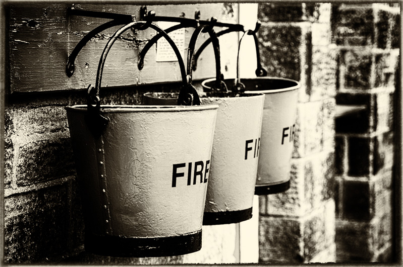 Three fire buckets on hooks.